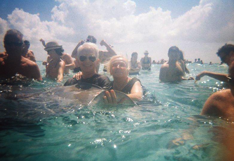 Susan & Allen M. Lawrence swimming with the sting rays in Grand Cayman